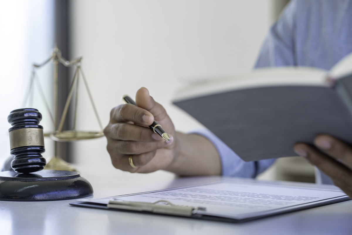 Lawyer taking notes on a clipboard with a paper