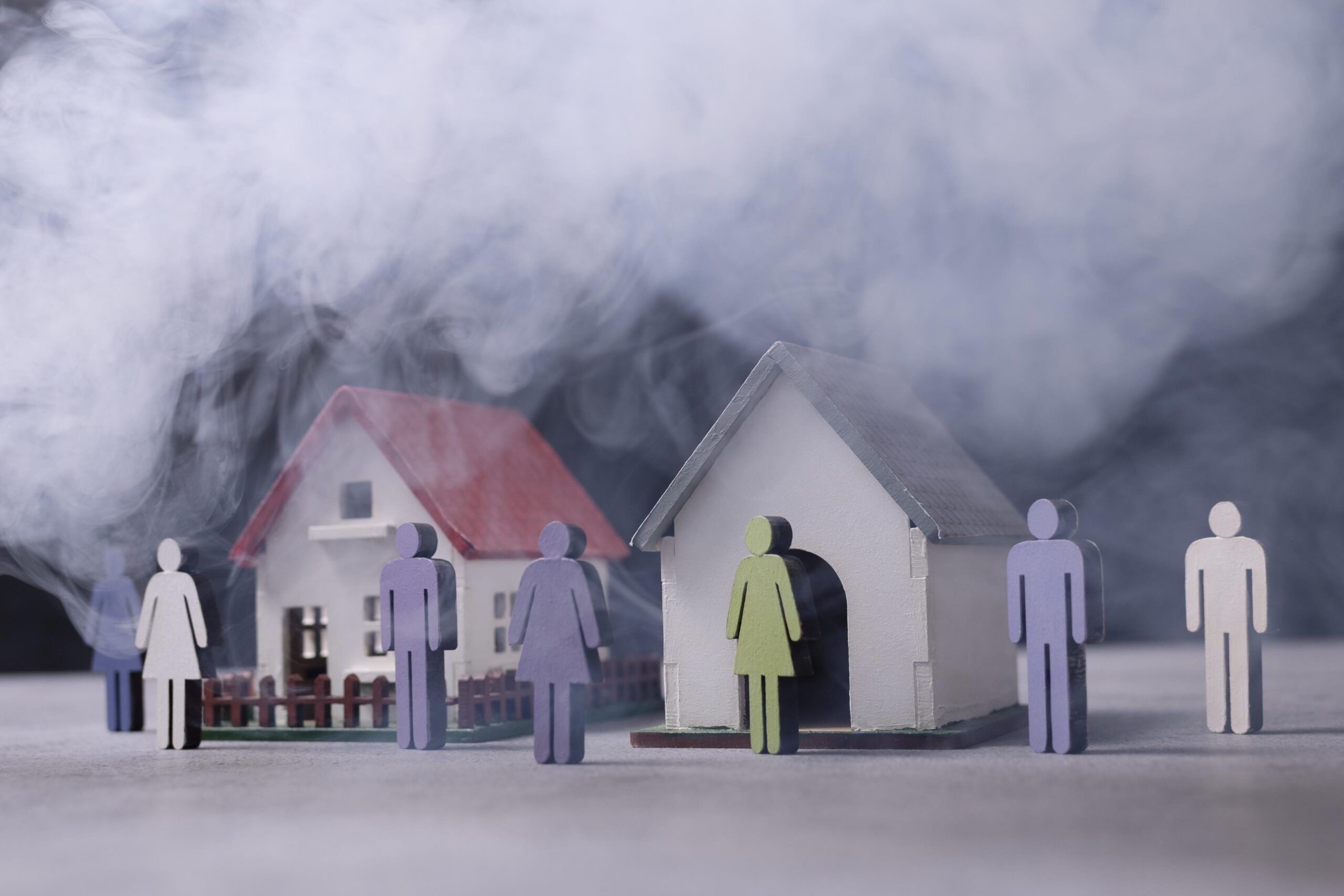 Wooden houses and people representing pollution made by humans