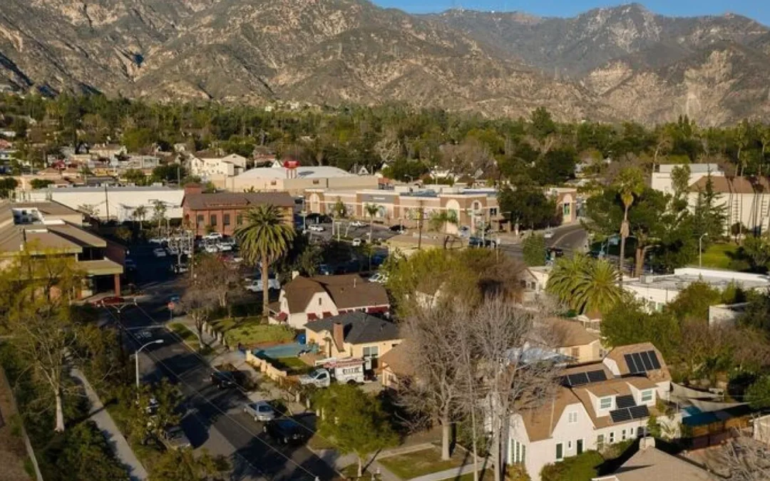 Southern California town or city with residential homes, commercial center, and the San Gabriel Mountains in the background